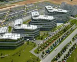 Vue aérienne de bâtiments modernes avec des parkings. On imagine un déjeuner d'affaires au restaurant La Javette.
